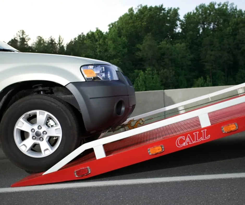 Minneapolis tow truck loading a vehicle on a residential street