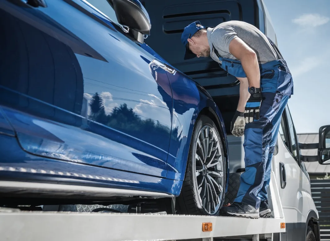 Minneapolis tow truck operator loading a vehicle